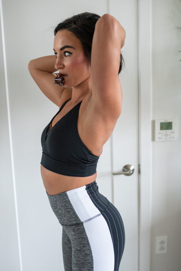 Model wearing Grey and White Leggings and Sports Bra.