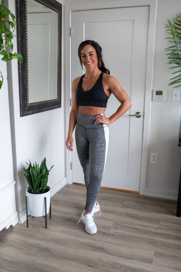 Model wearing Grey and White Leggings and Sports Bra.